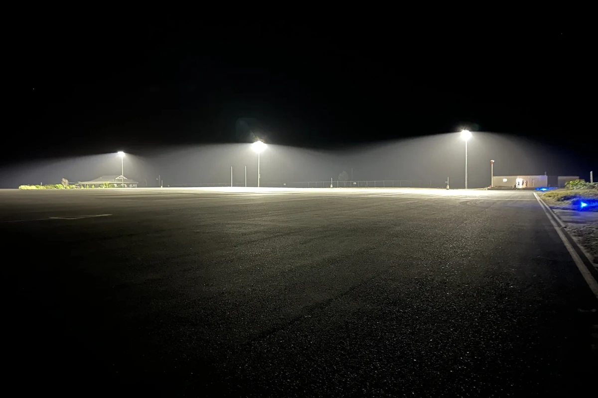 Hurricane-rated LED apron lighting illuminating the aircraft parking apron at Burton–Nibbs International Airport, Barbuda, at night