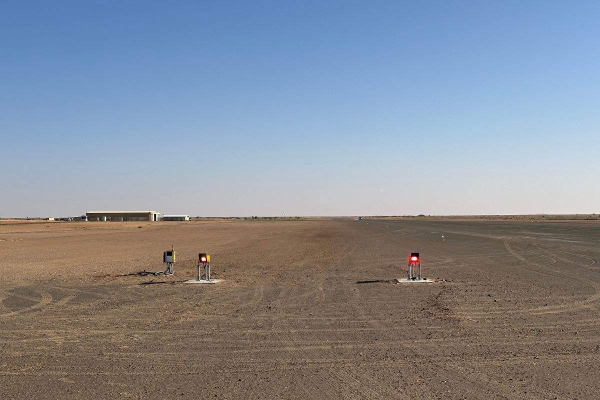 Two-box solar LED PAPI installed beside a gravel mine airstrip